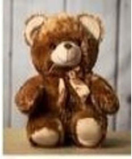 a sitting bear in your choice of white brown or tan with a red ribbon on the neck