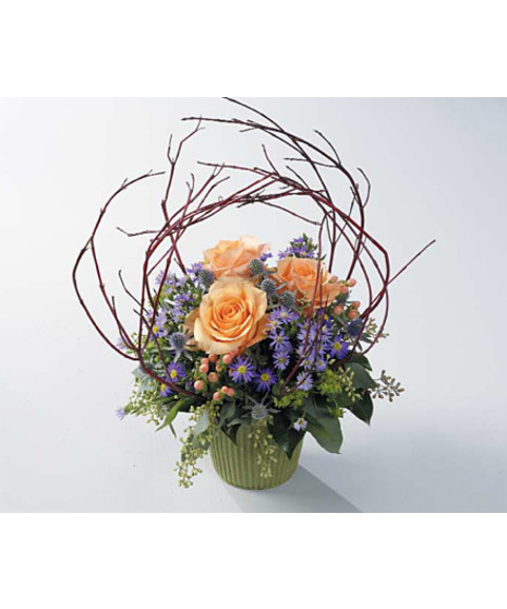 A compact arrangement with peach roses, hypericum , purple monte casino, eryngium, seeded eucalyptus and dogwood or curly willow branches comes in a garden pot container. .
