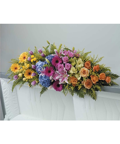 Casket spray comes with stargazer lilies, blue hydrangeas, yellow gerbera, buttons, freesia,solidago, green hypericum,gladiola, lavender roses,tulips, apricot roses, and ferns