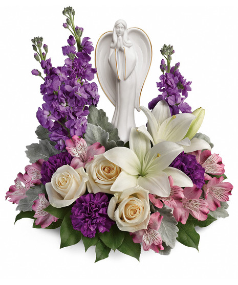 creme, white and lavender blooms includes fragrant roses and lilies to refresh and rejuvenate their spirits. Nestled among the blooms is a graceful angel sculpture -