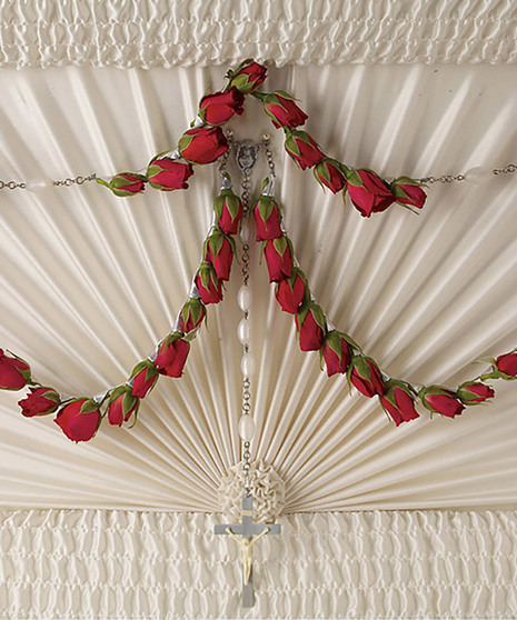 red spray rose rosary shown attached to  inside of casket lid