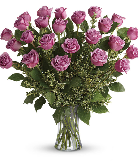 lavender roses come arranged with salal and seeded eualyptus in clea glass vase