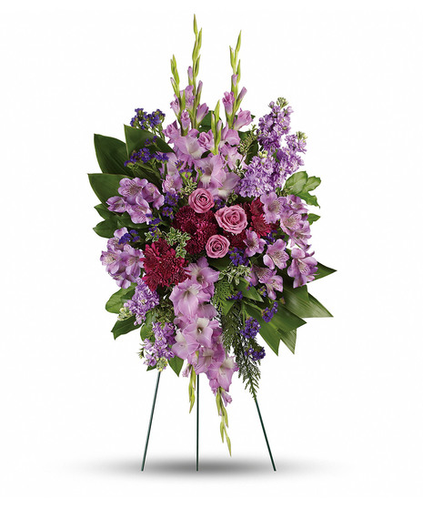 Spray on green wire easel with lavender gladiola, roses, alstoremeria, purple stock, and mums with salal, ti leaves, oregonia, myrtle, salal 