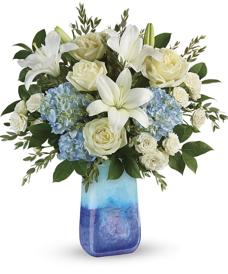 lapis blue gemstone vase wit blue hydrangea, white roses, spray roses, lilies, mini carnations