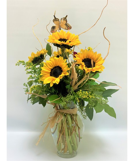 sunflowers come arranged in clear glass vase with salal, leather leaf, curly willow , eucalyptus, solidago and butterfly