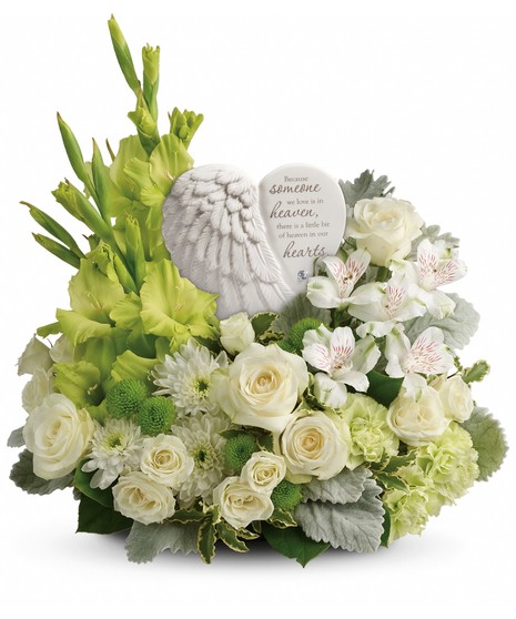 angel wing keepsake surrounded by green gladiola, green buttons, dusty miller, variegated pittosporum, white roses, spray roses, alstroemeria and mums  