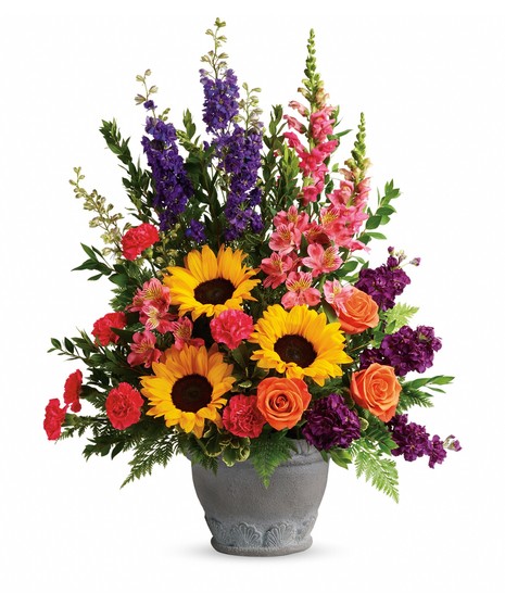 resin planter with sunflowers, orange roses, purple larkspur & delphinium, pink carnations and alstroemeria, leather leaf, salal, emerald one sided