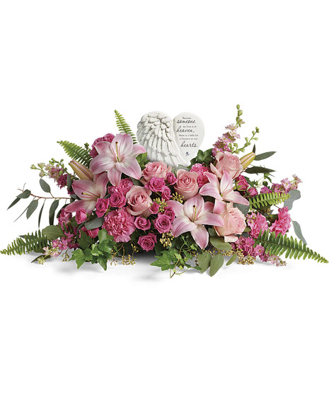 pink lilies,roses, spray roses, hydrangea, larkspur with fern, salal, surround ceramic wings keepsake