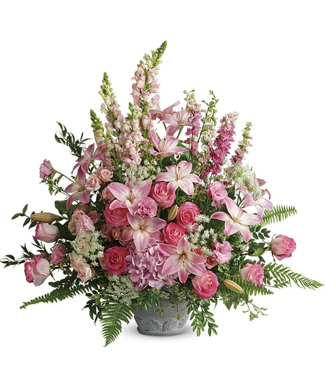 pink snap draogons, roses, lilies, hydrangea, larkspur, lisianthus with fern, salal in resin grey pot