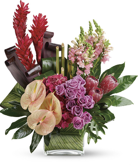 Leaf lined cube has pink antherium, hydrangea, proteas, ginger & snaps, lavender roses, with Ti , philadendron, clathea leaves -3 sided to make a striking tropical arrangement