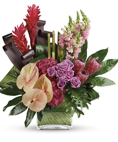 Leaf lined cube has pink antherium, hydrangea, proteas, ginger & snaps, lavender roses, with Ti , philadendron, clathea leaves -3 sided to make a striking tropical arrangement