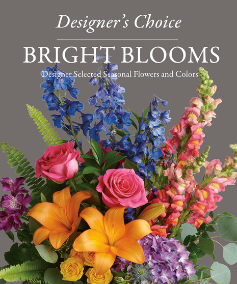 designer's chocie of bright flowers shown orange lilies, hot pink roses, blue delphinium, pink snapdragons, purple hydrangea