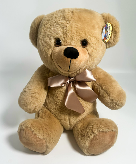 a sitting bear in your choice of white brown or tan with a red ribbon on the neck