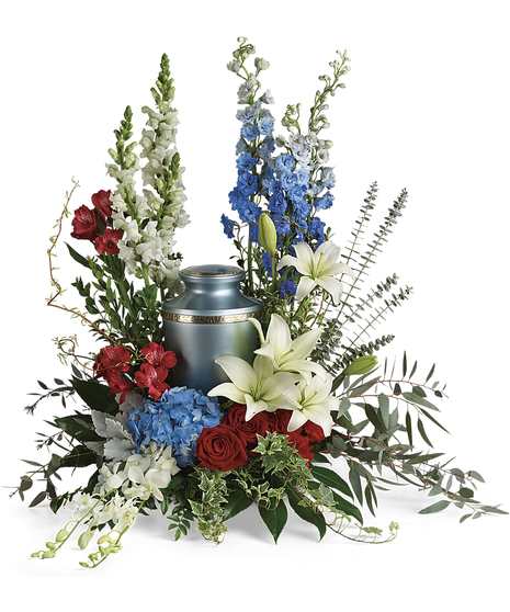 Blue hydrangea, delphinium, white snap dragons, orchids, lilies , red alstroemeria, roses, eucalyptus, dusty miller, myrtle displayed with silver urn in middle(not included)
