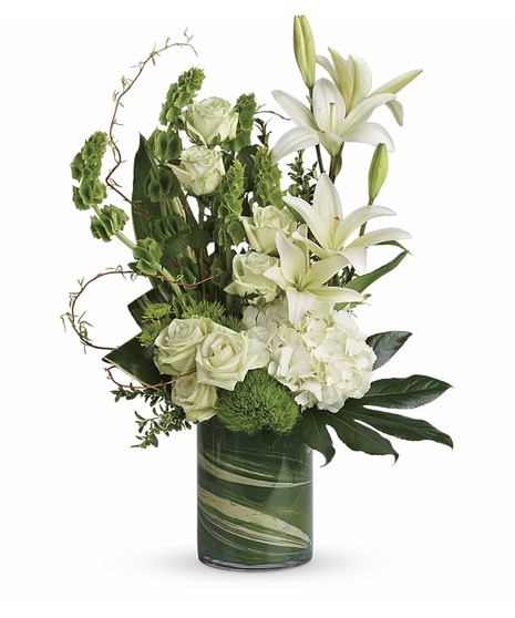 modern bouquet has white hydrangea, lilies, green roses, dianthus, bells of Ireland, button  curly willow, oregonia, aspidistra, aralia ti leaf, in leaf lines cylinder
