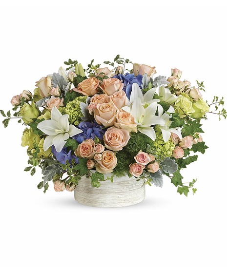 off white ceramic, white lilies, peach roses & spray rose, green hydrangea, roses, dianthus, dusty miller, blue hydrangea, ivy, seed eucalyptus create elegant masterpiece