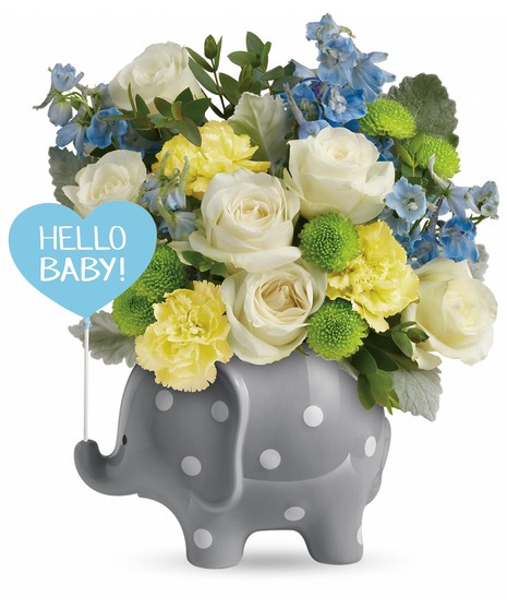  white roses, yellow carnations, light blue delphinium, green button spray chrysanthemums, parvifolia eucalyptus, and dusty miller. Delivered in a Hello Baby Elephant.